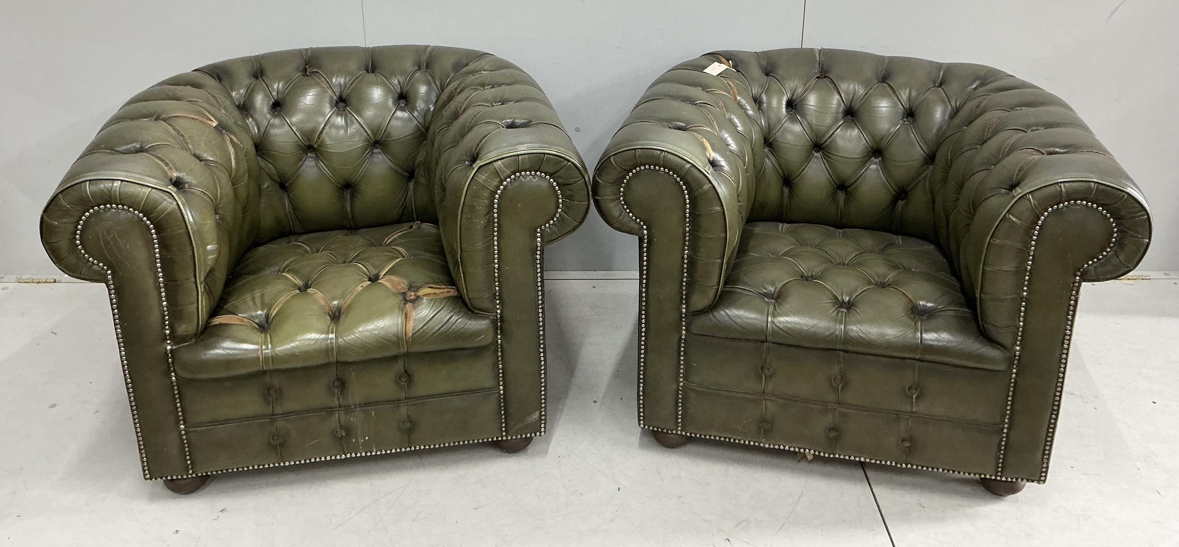 A pair of Chesterfield style buttoned green leather club armchairs, width 104cm, depth 92cm, height 74cm